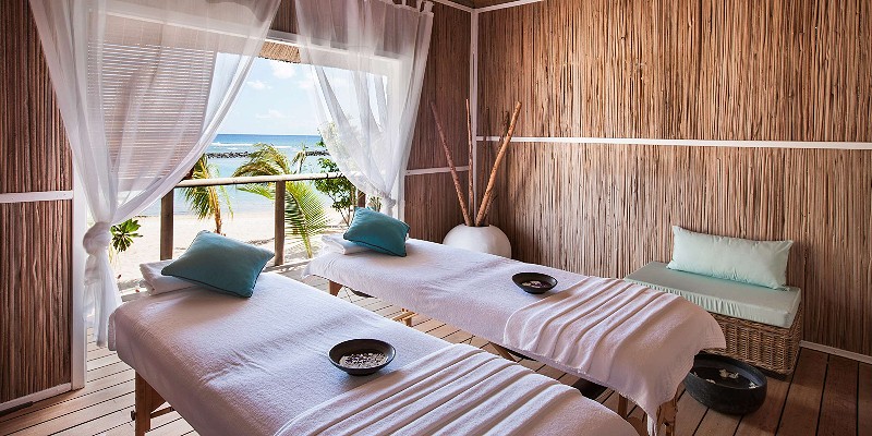 Spa beds in a thatched hut overlooking the ocean