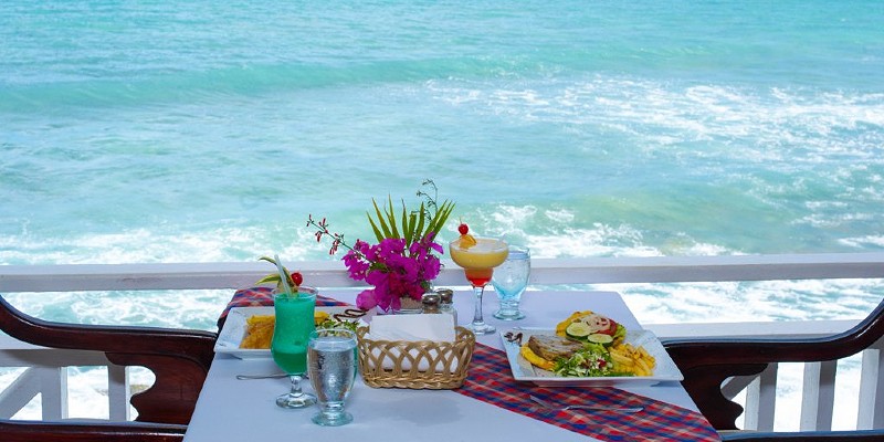 Table set for dinner with the ocean in the background