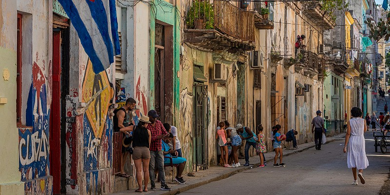 People talking and walking around a street in Havana, Cuba