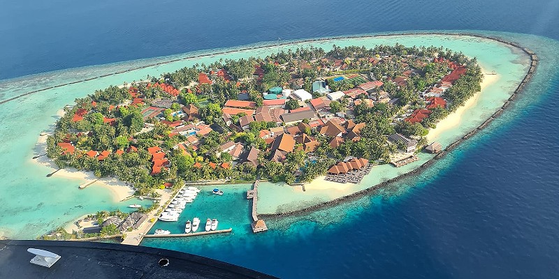 Aerial shot of a Maldivian island from the window of a seaplane