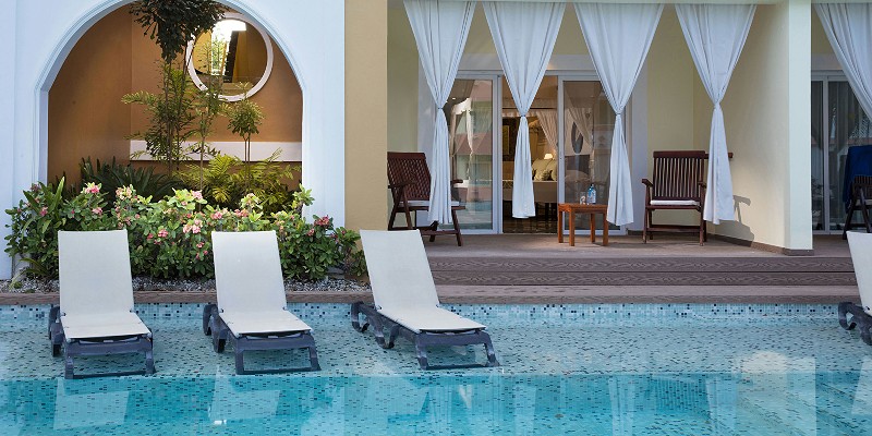 Sun loungers outside a poolside suite