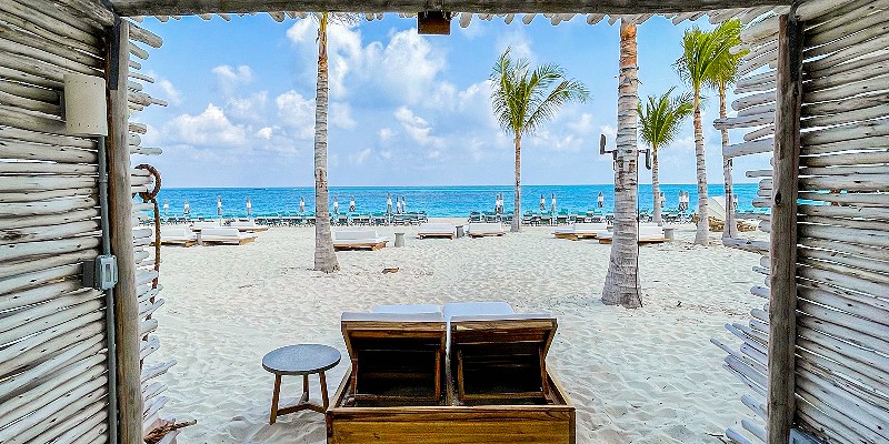 Two empty sun loungers on the bach at Bimini Beach Club