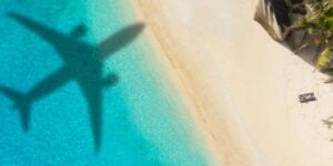 Plane flying over the beach with Direct Flights to the Maldives from the UK