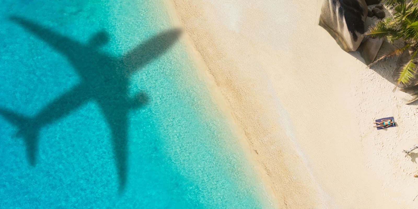 Plane flying over the beach with Direct Flights to the Maldives from the UK